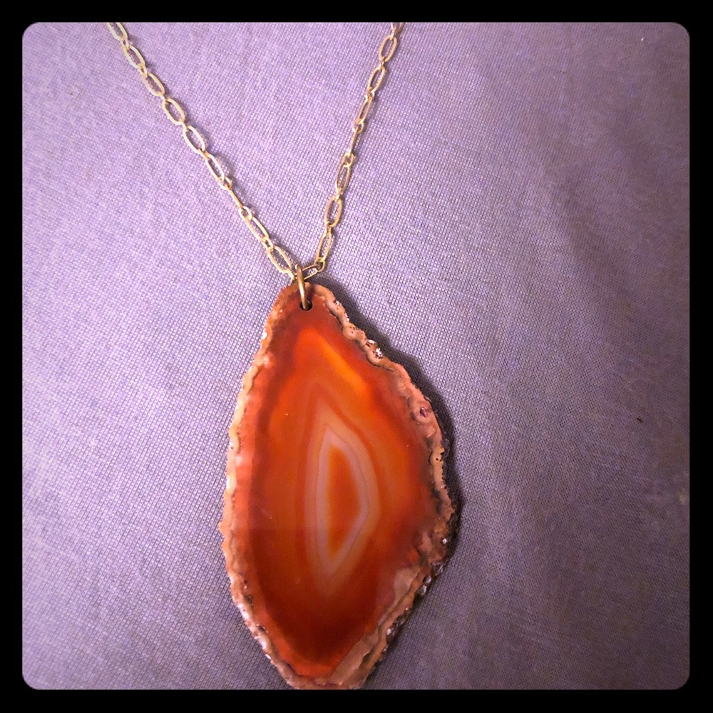 Large cross section stone, long gold chain.